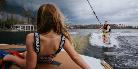 family enjoys wakeboarding before a storm arrives
